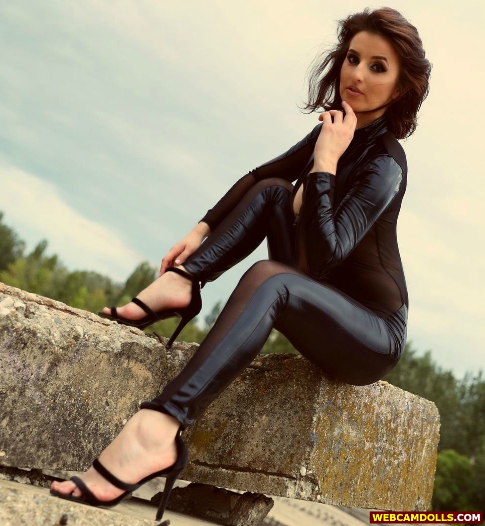 Brown Haired Girl in Black Leather Suit and Sandal Spike Heels on Webcamdolls